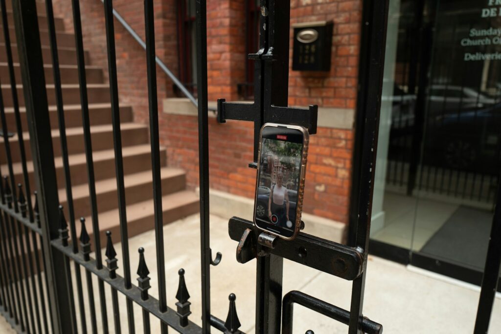 A cell phone is attached to a fence